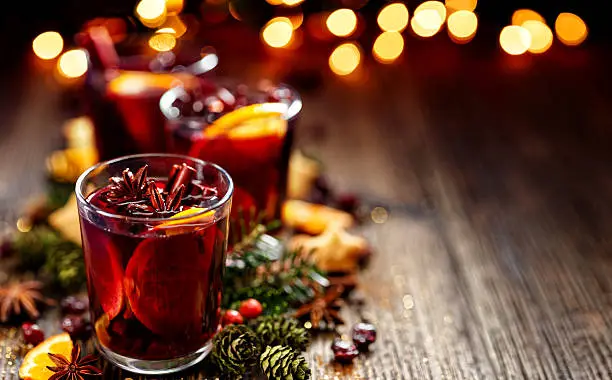 Christmas mulled red wine in a glass on a wooden table