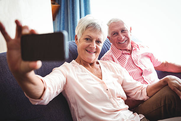 istock Smiling senior couple taking a selfie 614035320