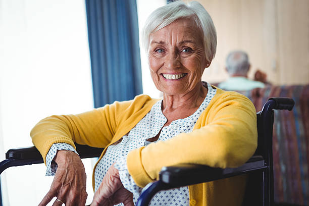 istock Smiling senior woman on a wheelchair 614035542