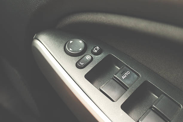 istock car interior details of door handle with windows controls 614036354