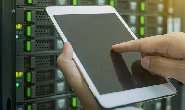 close up use tablet in data center for manage system stock photo
