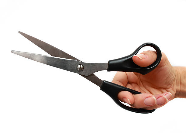 istock Hand is holding scissors isolated on a white background 614038176