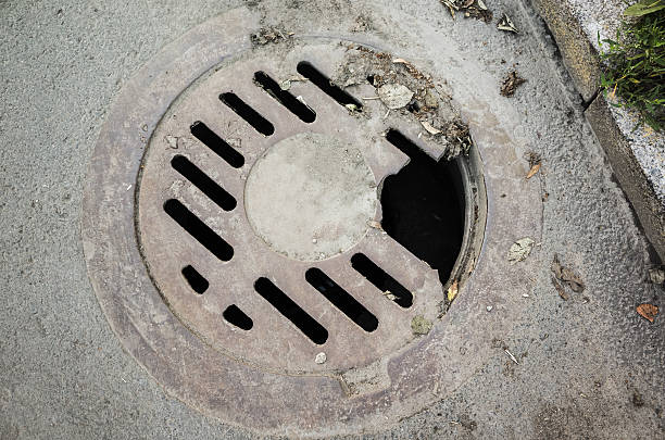 istock Old damaged sewer manhole cover 614038770