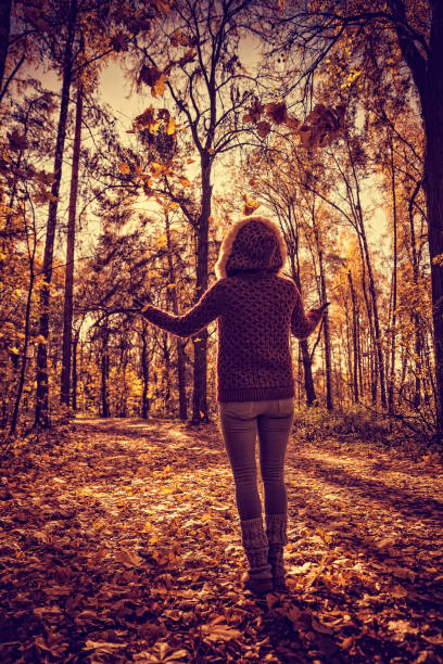 istock Woman in autumn park 614038910