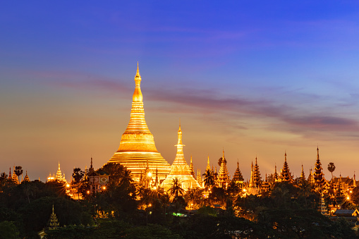 Aerial view of famous Shwedagon Pagoda in at Dusk, skyline cityscape view from above. Yangong, Myanmar, Burma, Asia.