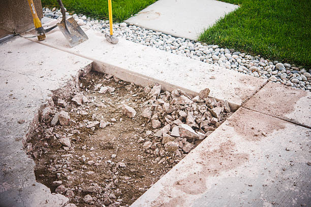 Partially removed concrete patio. Home construction and renovation