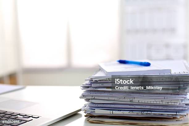 Stack Of Papers On The Desk With Computer Stock Photo - Download Image Now - Deadline, Efficiency, Excess