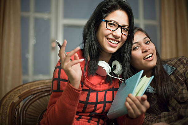 istock Confident happy girl students sitting together and looking at camera. 614044346
