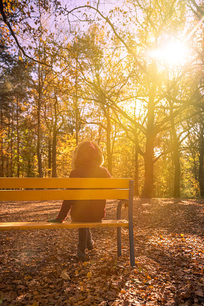 istock Woman in autumn park 614044848