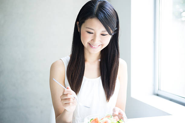 istock Woman eating salad 614045010