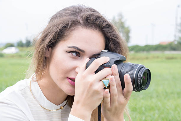 istock Beutiful Young Girl Posing With Photo Camera 614046806