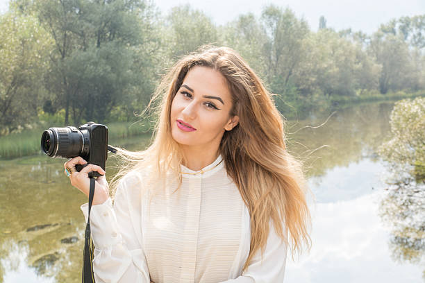 istock Beutiful Young Girl Posing With Photo Camera 614046944