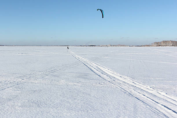 istock The  man skiing with a parachute on a snow field 614046958