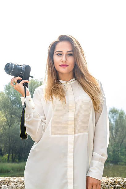 istock Beutiful Young Girl Posing With Photo Camera 614047004