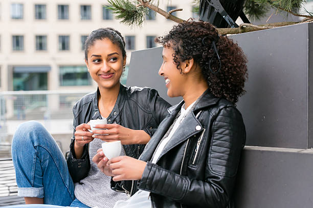 istock Best friends drinking coffee in city 614047598