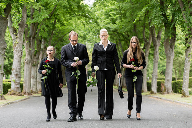 istock Family walking down alley at graveyard 614048540