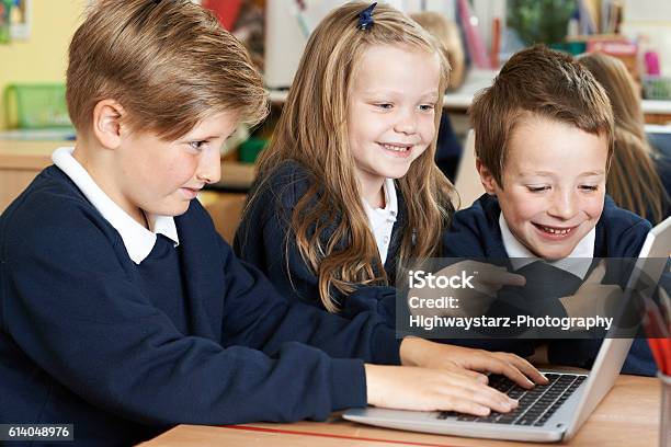 Group Of Elementary School Children Working Together In Computer Stock Photo - Download Image Now