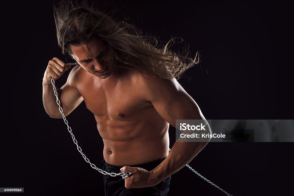 Young Man With Long Hair Dragging Something Behind Him Strong Stock Photo -  Download Image Now - iStock