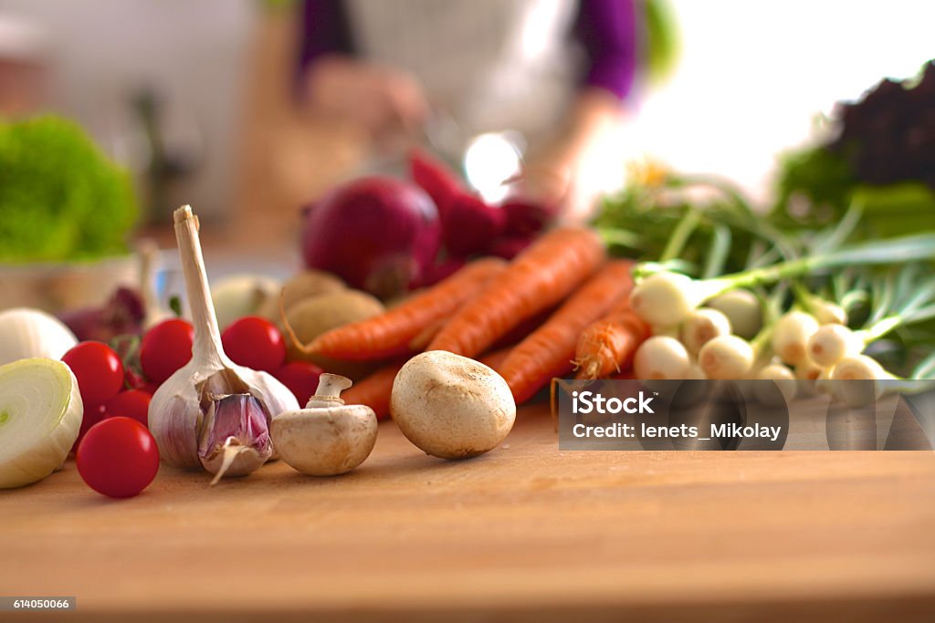 Young Woman Cooking in the kitchen. Healthy Food Young Woman Cooking in the kitchen. Healthy Food. Adult Stock Photo