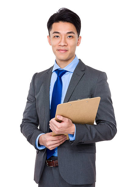 istock Young business man holding a clip board 614050076