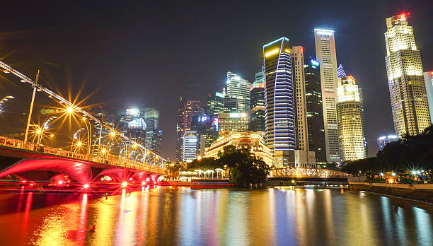 istock Modern buildings at night in Singapore 614051896