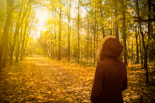 istock Woman in autumn park 614052512