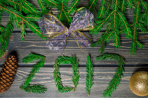 istock Christmas Fir Tree On Wooden Background With cones 614052520