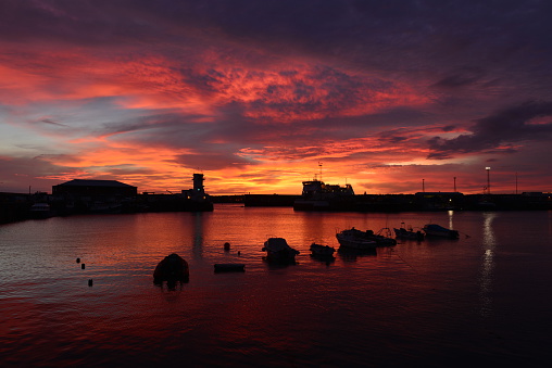 Wide angle image of a dramatic sunset with a high tide in late Summer.