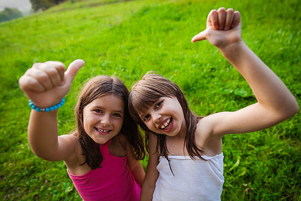 istock Two happy girls outside 614054616