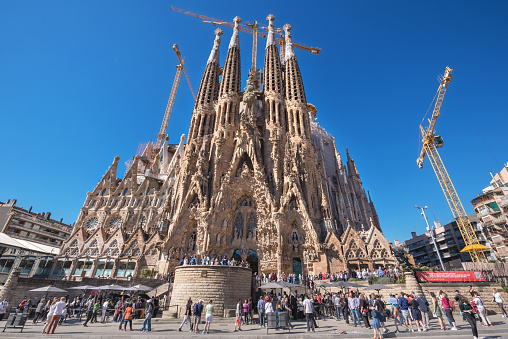 Barcelona, Spain - May 3, 2016: Tourist visiting Cathedral of La Sagrada Familia on May 3, 2016 in Barcelona, Spain.  It is designed by architect Antonio Gaudi and is being build since 1882.