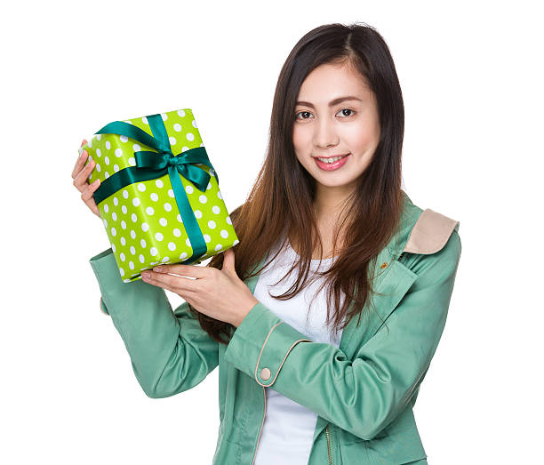 istock Asian young woman holding a gift box 614055606