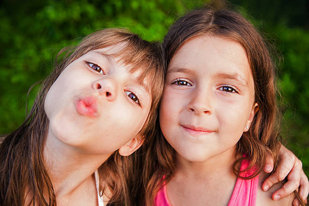 istock Two happy girls outside 614055676