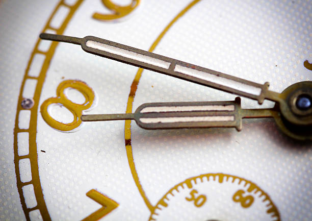 istock Closeup of hands on clock face 614056284