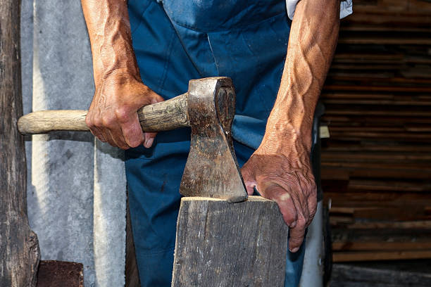 istock The worker, a man with an ax chopping firewood 614056472