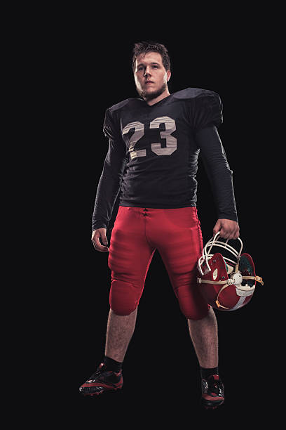 istock Football player on dark background 614056700