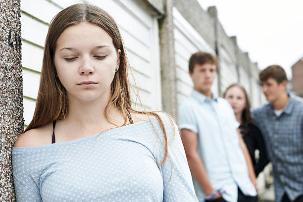 Unhappy Teenage Girl Being Talked About By Peers Unhappy Teenage Girl Being Talked About By Peers teasing photos stock pictures, royalty-free photos & images