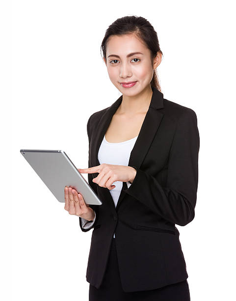 istock Asian young business woman holding a tablet 614110970