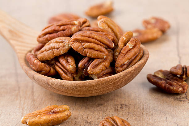 istock pecan nuts in a wooden spoon 614111656