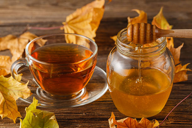 istock rose hip tea in transparent cup and teapot with honey 614114646