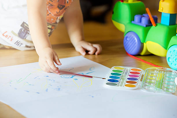 istock Kid painting with watercolors 614115048