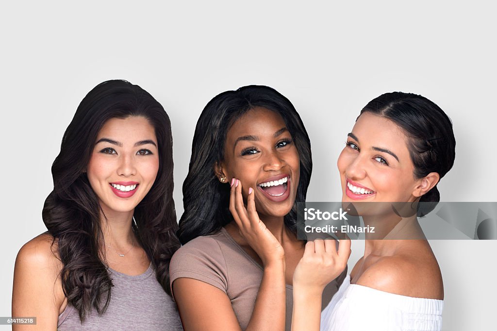 Mixed race multi-ethnic female friends laughing together perfect smile Group beautiful women people multiple ethnicity perfect smile white teeth lips skin mixed race multi-ethnic female friends having fun natural and laughing together Women Stock Photo