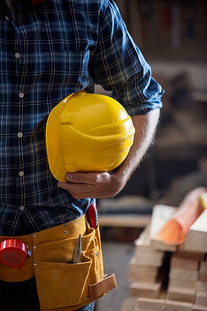 istock Carpenter  holding yellow hemlet 614118704
