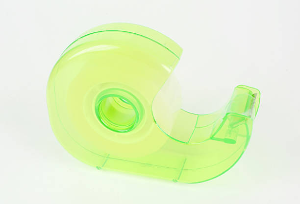 istock green Scotch tape holder on white background 614119448