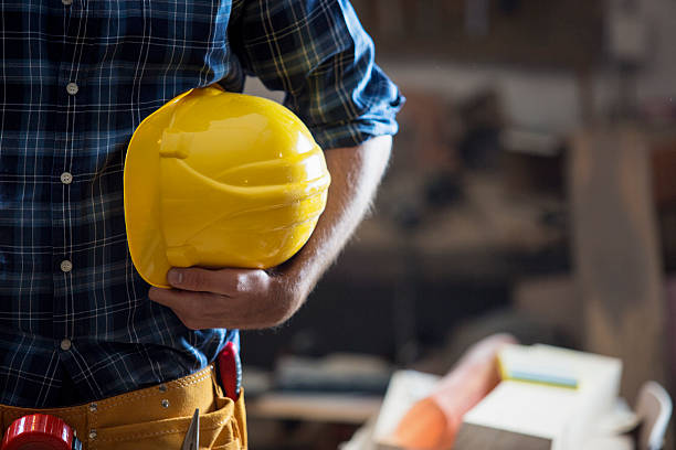 construction worker holding yellow hemlet - holding screwdriver imagens e fotografias de stock