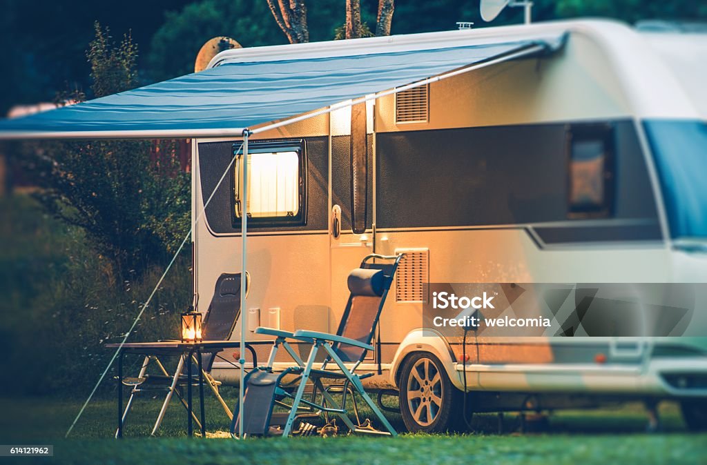 Travel Trailer Caravaning Travel Trailer Caravaning. RV Park Camping at Night. Camping Stock Photo