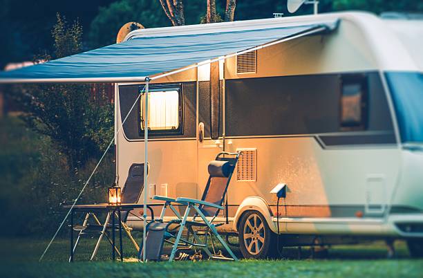 Travel Trailer Caravaning Travel Trailer Caravaning. RV Park Camping at Night. camper trailer photos stock pictures, royalty-free photos & images