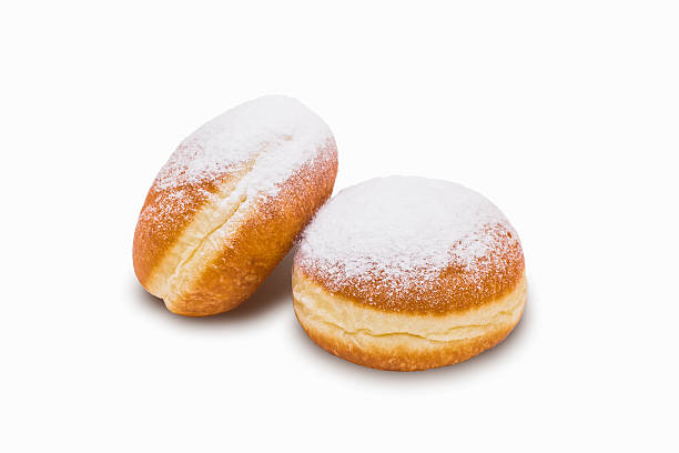 istock Two donuts in powdered sugar. Isolated on white background 614122584