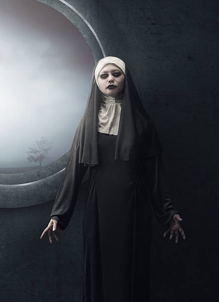 Creepy asian woman nun standing Creepy asian woman nun standing beside the dark window angry nun stock pictures, royalty-free photos & images