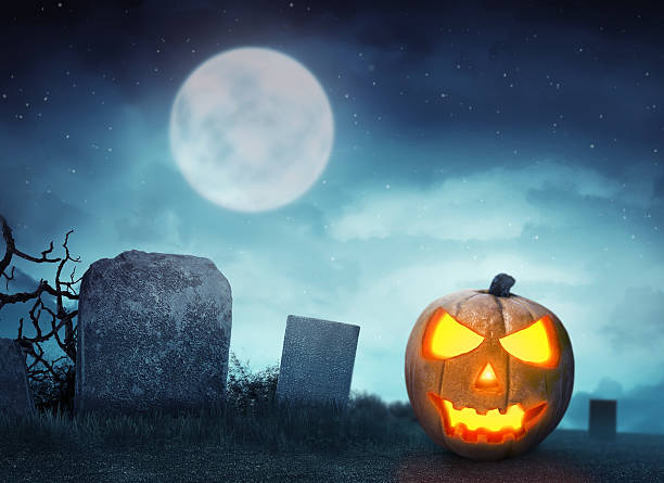 istock Spooky cemetery with glow halloween pumpkin 614122772
