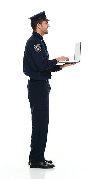 istock Smiling police working on laptop 614123256